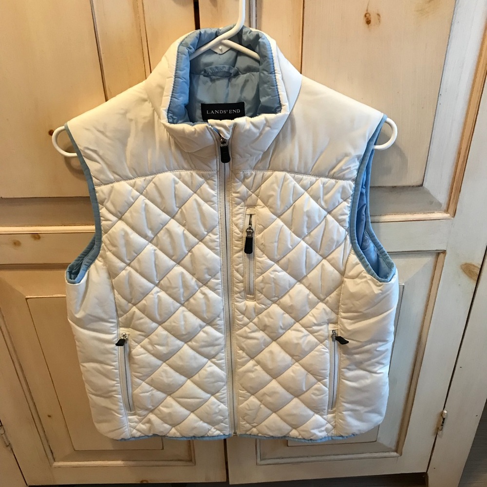White primaloft puffer vest with light blue trim.